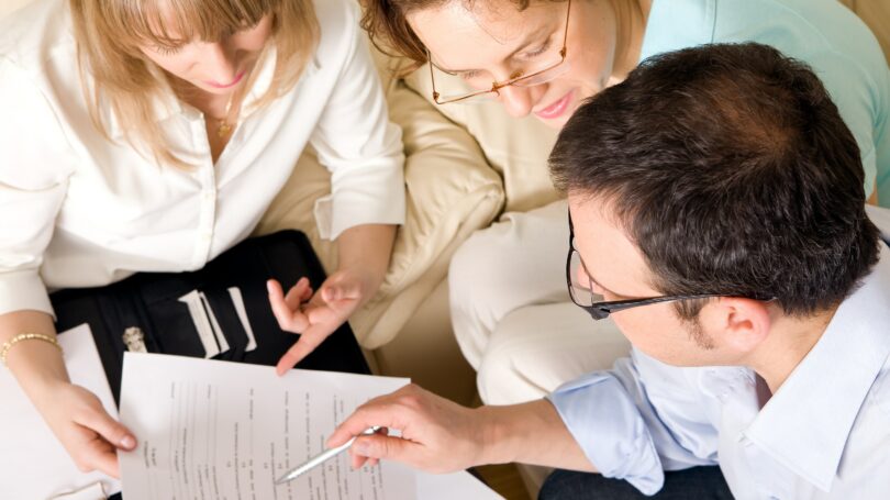 People Looking Over Financial Document