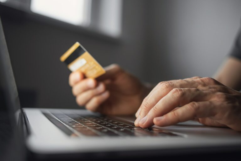 Man Using Laptop With Credit Card