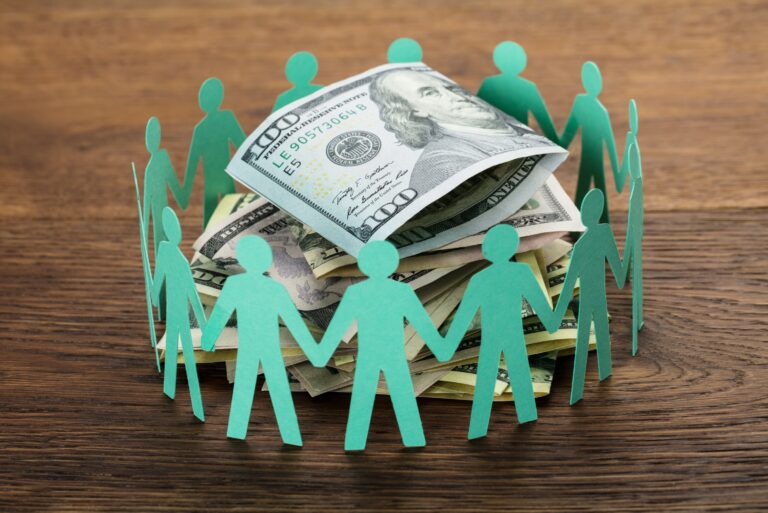 Paper Stick Men Surrounding Money Pile