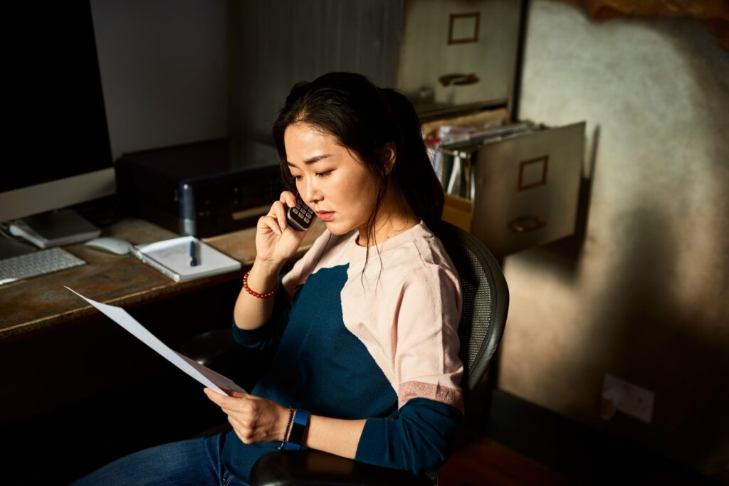 Woman On Phone With Document